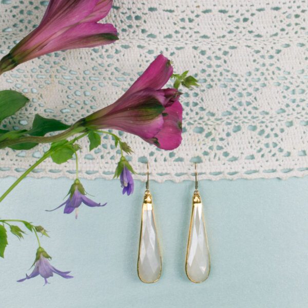 A pair of earrings sitting on top of a table.