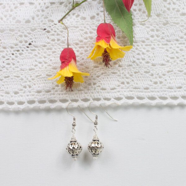 A pair of earrings sitting on top of a table.