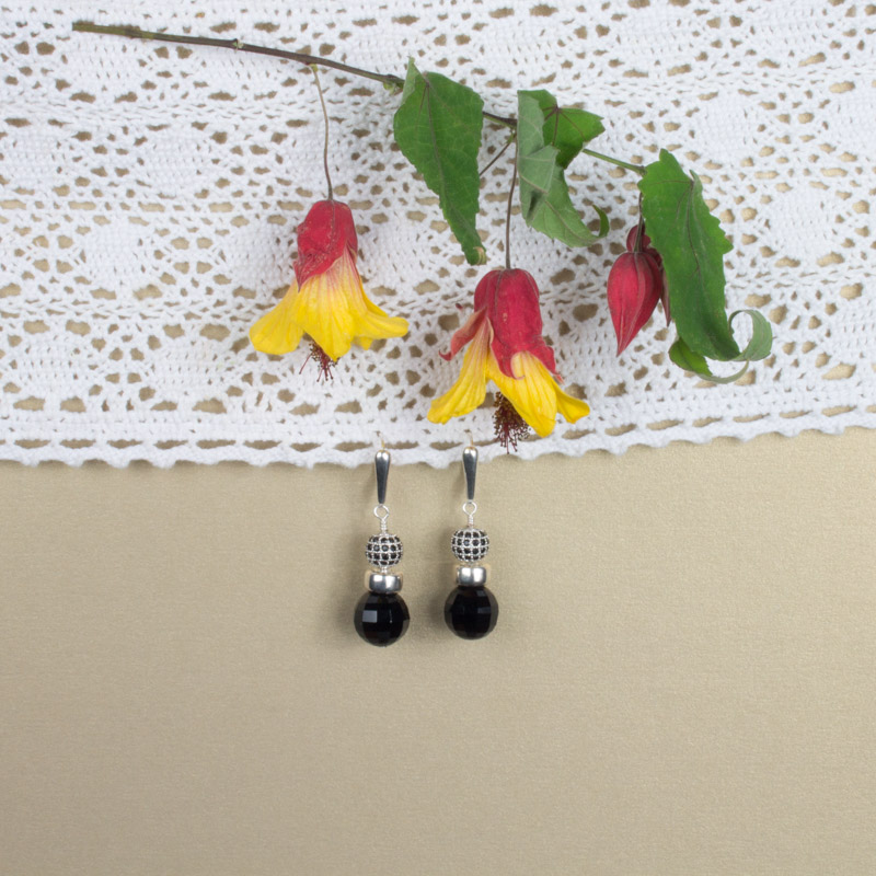 A pair of earrings hanging on the wall