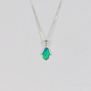 A silver necklace with an emerald colored stone.