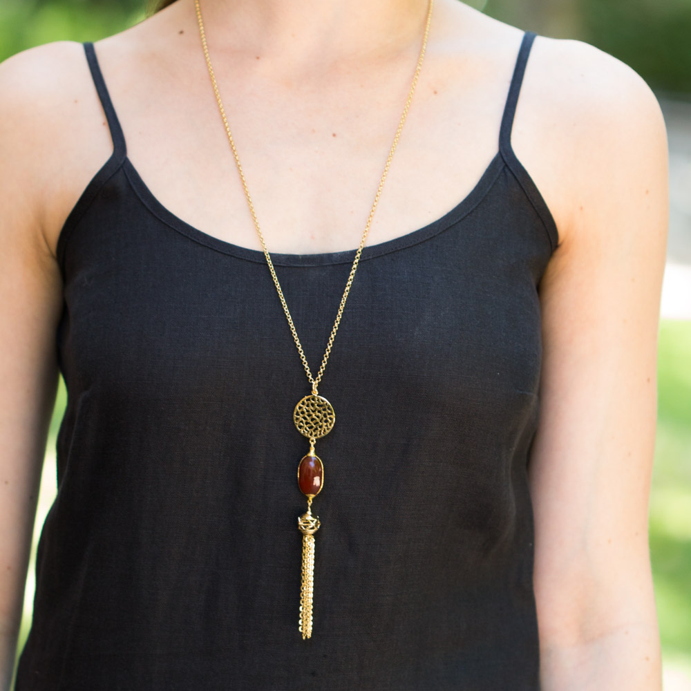 A long necklace with three stones as the pendant.