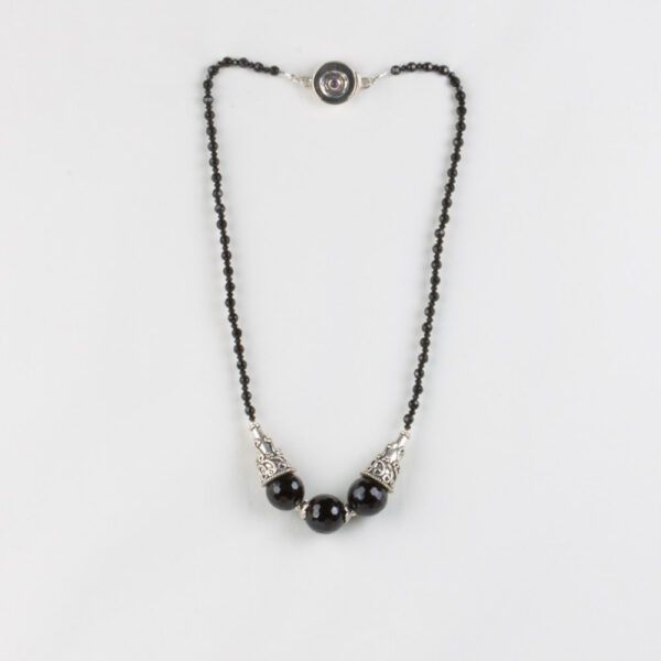 A black bead necklace with silver accents.