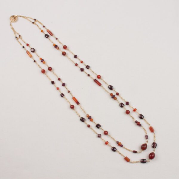 A long necklace with red and blue beads