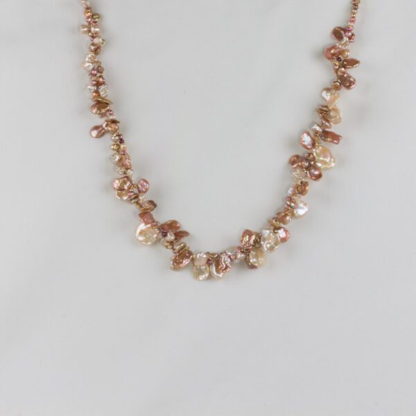 A necklace with pink pearls on it.