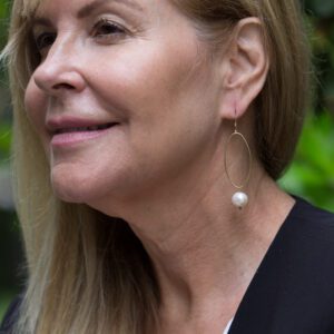 A woman with long blonde hair wearing a black shirt.