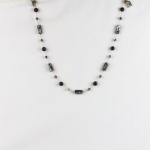 A necklace with black beads and white stones.