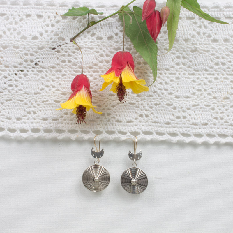 A pair of earrings sitting on top of a table.