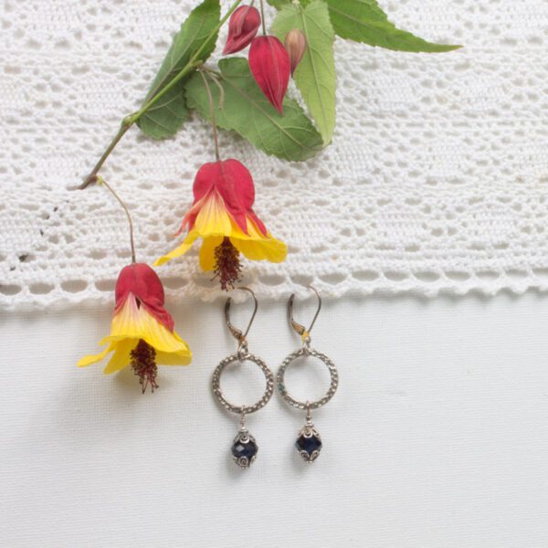 A pair of earrings sitting on top of a table.