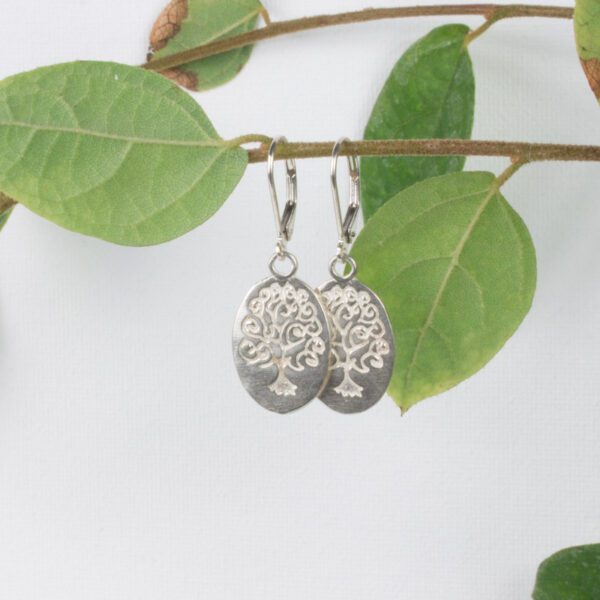 sterling silver oval earrings with tree of life design etched into it