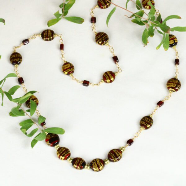 long necklace with garnets and gold/garnet colored glass beads