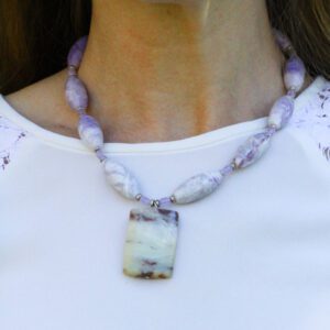 A woman wearing purple lepidolite stone necklace