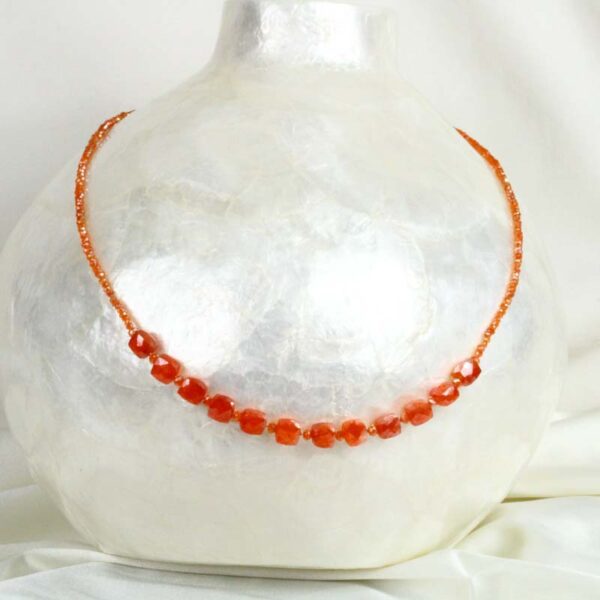 Square Carnelian necklace on a white vase