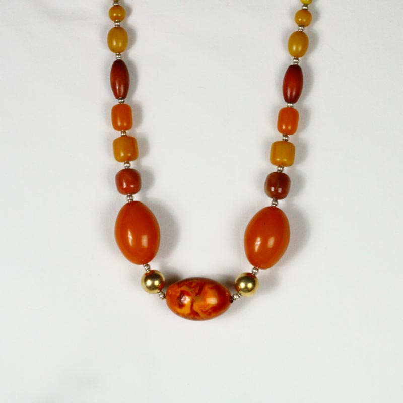 Large orange beads with gold and brown accents.