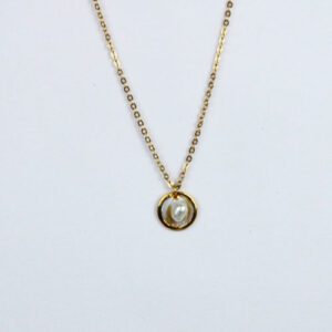 A gold necklace with a blister pearl.